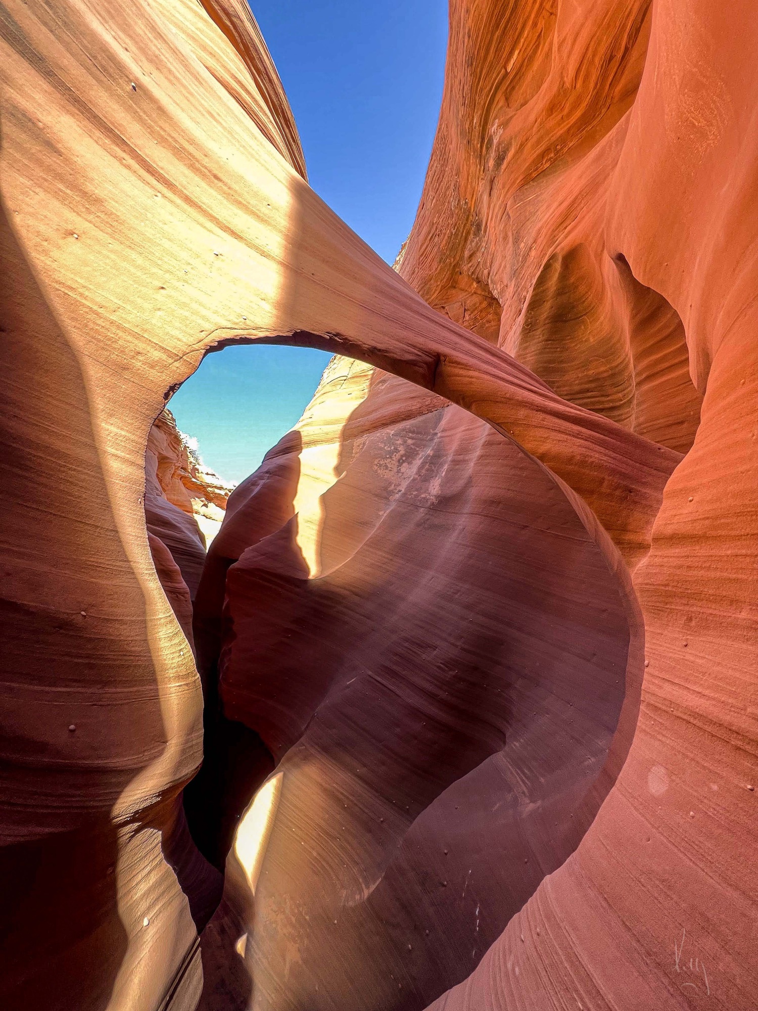 Inside the slot canyon, light falling on sculpted sandstone.