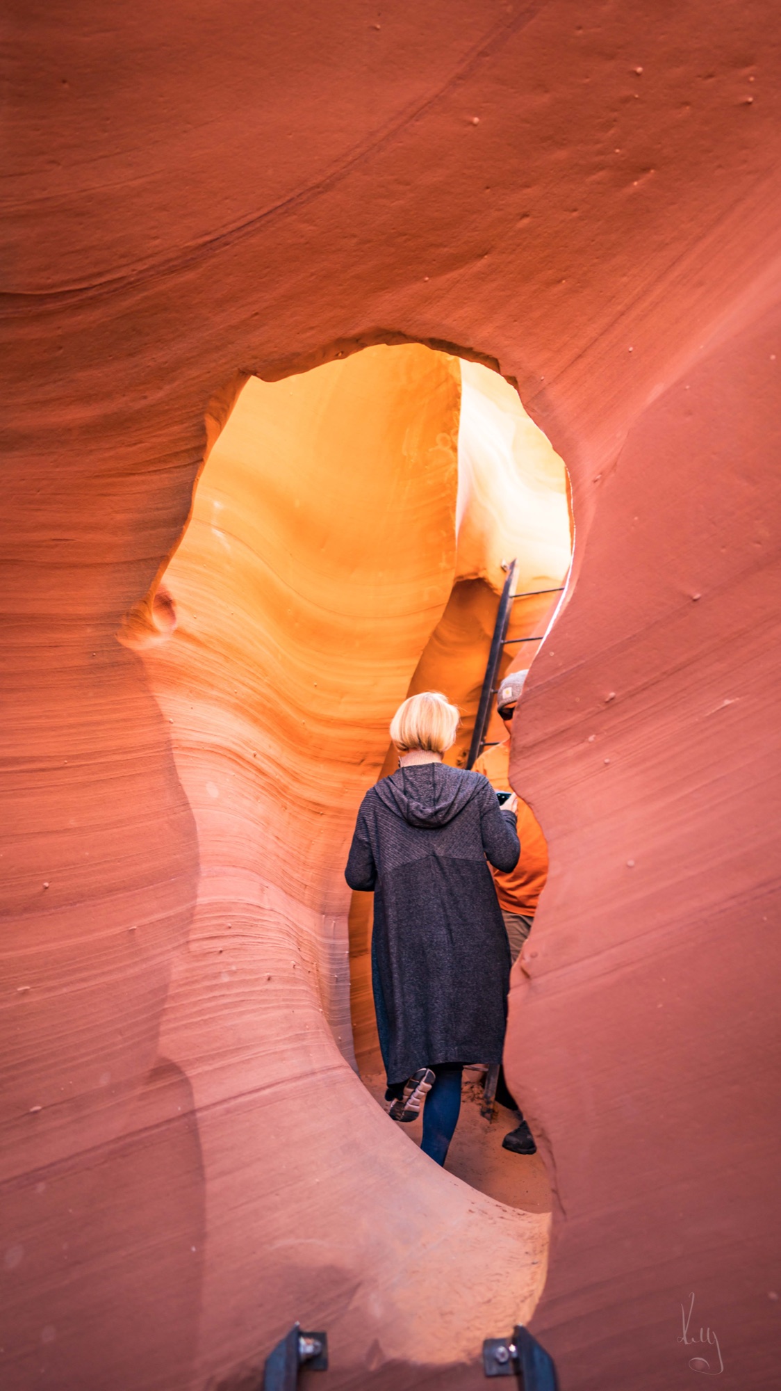 A tall, narrow slot canyon carved by water.